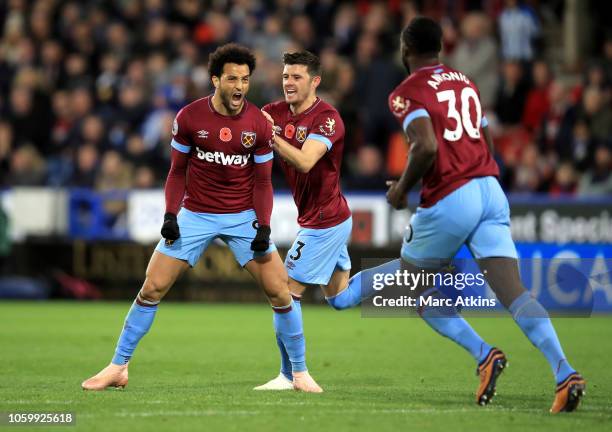 Felipe Anderson of West Ham United celebrates with teammates after scoring his team's first goal during the Premier League match between Huddersfield...