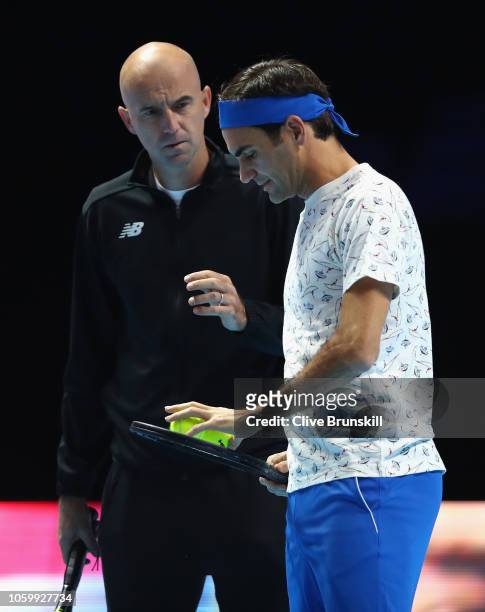 Roger Federer of Switzerland talks with his coach Ivan Ljubcic during a training session prior to the Nitto ATP World Tour Finals at O2 Arena on on...