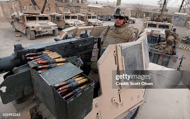 Marine Cpl. Daniel Hauser of Maple Grove, MN with India Battery, 3rd Battalion, 12th Marine Regiment prepares to escort a patrol outside Forward...