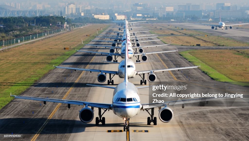 So many airplanes are in line on the runway waiting for take off