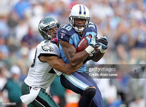 Kenny Britt of the Tennessee Titans catches a pass while defended by Nate Allen of the Philadelphia Eagles during the NFL game at LP Field on October...