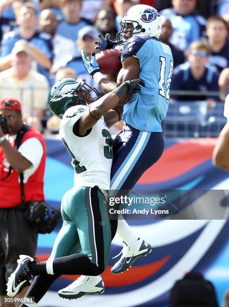 Kenny Britt of the Tennessee Titans catches a touchdown pass while defended by Ellis Hobbs of the Philadelphia Eagles during the NFL game at LP Field...