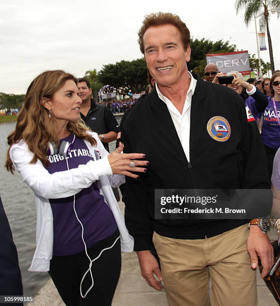 Maria Shriver and Governor of California Arnold Schwarzenegger walk during Maria Shriver's Women's Conference at the Long Beach Convention Center on...