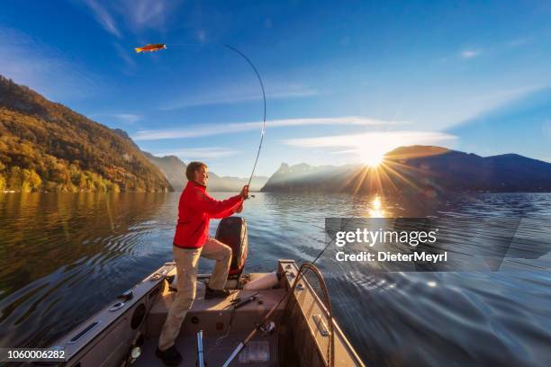 enjoy my leisure time - fishing at alpin lake - boat in lake stock pictures, royalty-free photos & images