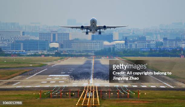front view of a airplane taking off from runway - airplane runway stockfoto's en -beelden