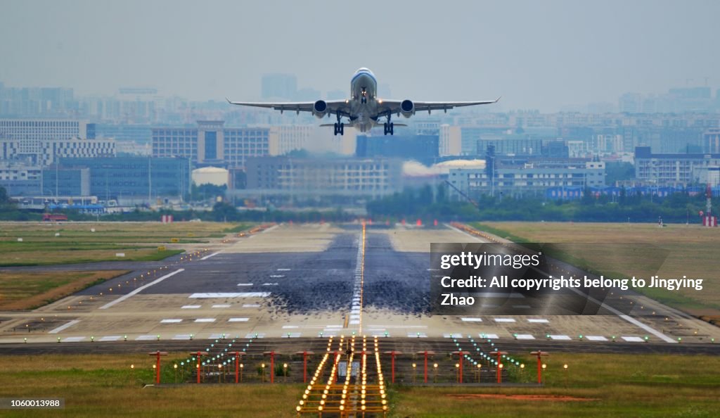 Front view of a airplane taking off from runway