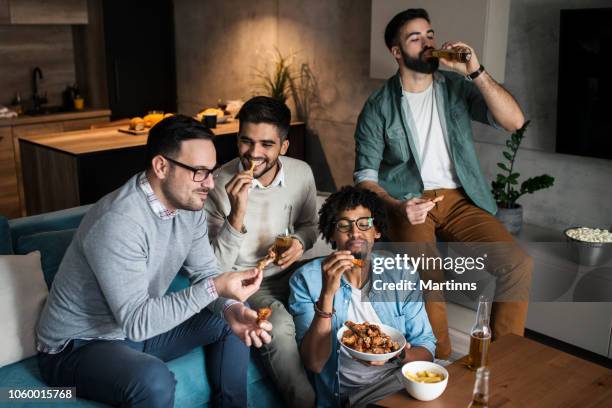 friends at home eating fast food - chicken wing stock pictures, royalty-free photos & images