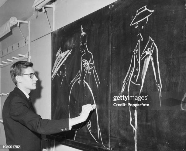 French fashion designer Yves Saint Laurent , working on new designs at the House of Dior in Paris, circa 1960.