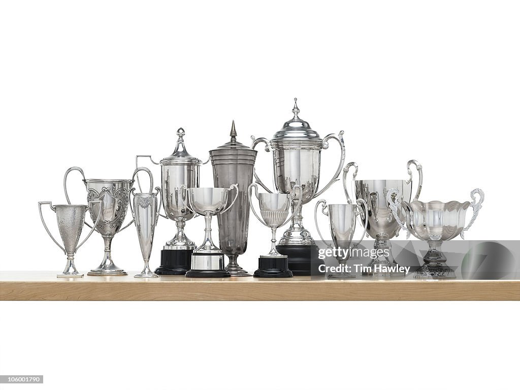 11n Silver trophies on maple shelf