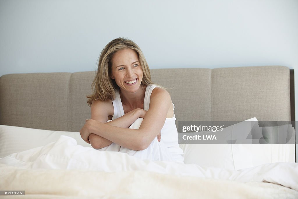 Smiling Woman Sitting In Bed