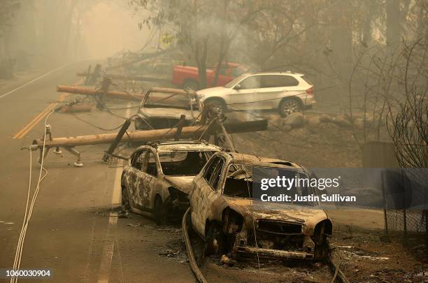 Power lines rest on cars that were burned by the Camp Fire on November 10, 2018 in Paradise, California. Fueled by high winds and low humidity, the...