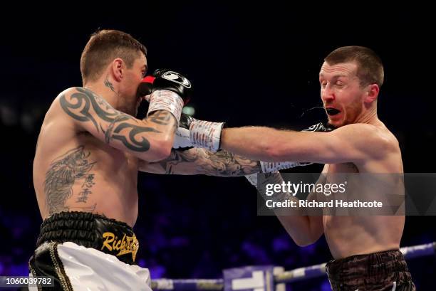 Scott Cardle of England punches Ricky Burns of England during the Lightweight Contest between Ricky Burns and Scott Cardle at Manchester Arena on...