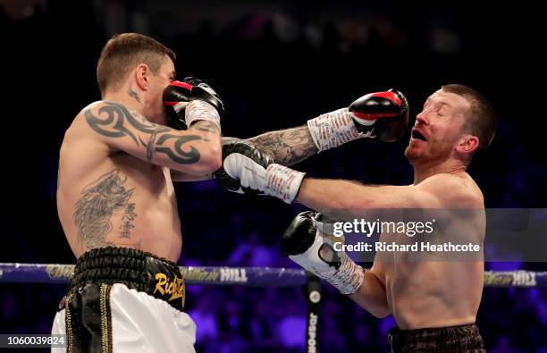 Ricky Burns of England and Scott Cardle of England exchange punches during the Lightweight Contest between Ricky Burns and Scott Cardle at Manchester...