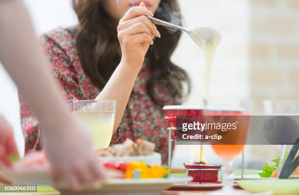 woman to eat - cheese fondue stock pictures, royalty-free photos & images