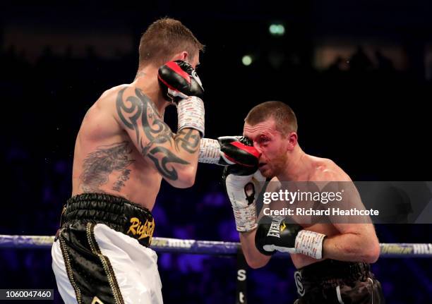 Ricky Burns of England punches Scott Cardle of England during the Lightweight Contest between Ricky Burns and Scott Cardle at Manchester Arena on...