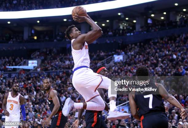 Frank Ntilikina of the New York Knicks shoots the ball as Kyle Lowry of the Toronto Raptors defends during the first half of an NBA game at...