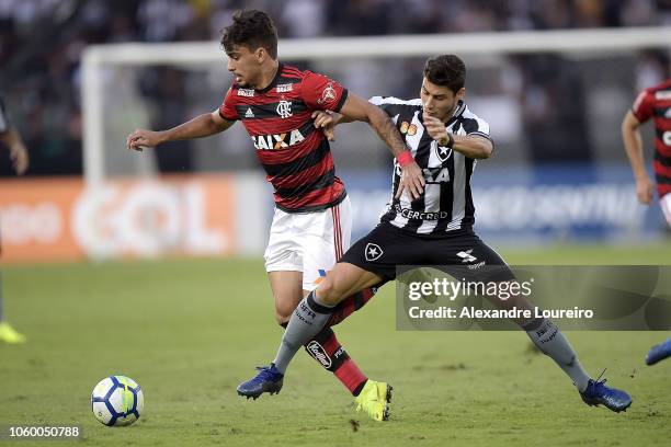 Marcinho of Botafogo struggles for the ball with Lucas Paquetá of Flamengo during the match between Botafogo and Flamengo as part of Brasileirao...