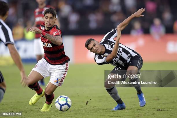 Erik of Botafogo struggles for the ball with Lucas Paquetá of Flamengo during the match between Botafogo and Flamengo as part of Brasileirao Series A...