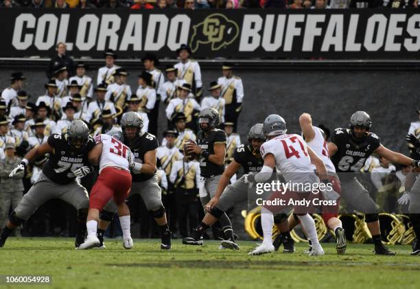 Colorado Buffaloes quarterback Steven Montez scans the field looking for an open receiver against Washington State in the second quarter at Folsom...