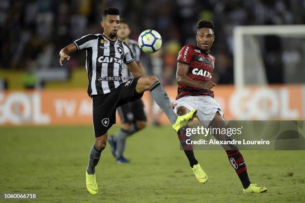 Matheus Fernandes of Botafogo struggles for the ball with Vitinho of Flamengo during the match between Botafogo and Flamengo as part of Brasileirao...