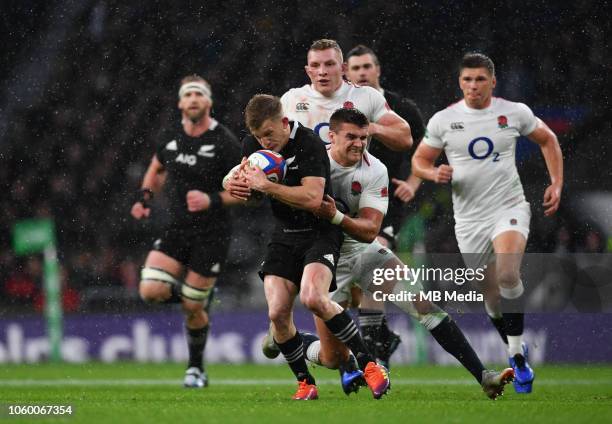 New Zealand's Damian McKenzie is tackled by England's Henry Slade during the Quilter International match at Twickenham Stadium on November 10, 2018...