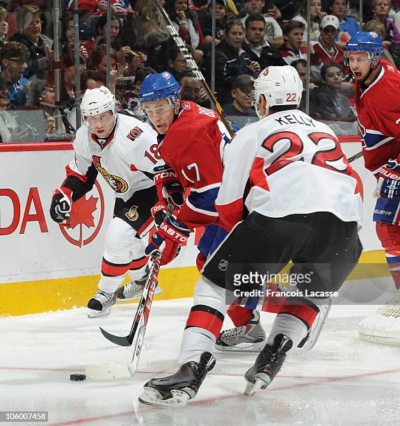 Dustin Boyd of the Montreal Canadiens reaches for a loose puck first during the NHL game on October 16, 2010 at the Bell Centre in Montreal, Quebec,...