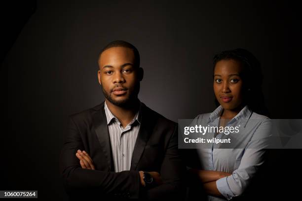 formal business portrait of successful young african businessman in front of a businesswoman - formal office stock pictures, royalty-free photos & images