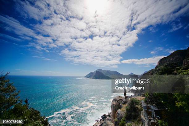 looking out from chapman's peak arms raised - chapmans peak stock pictures, royalty-free photos & images