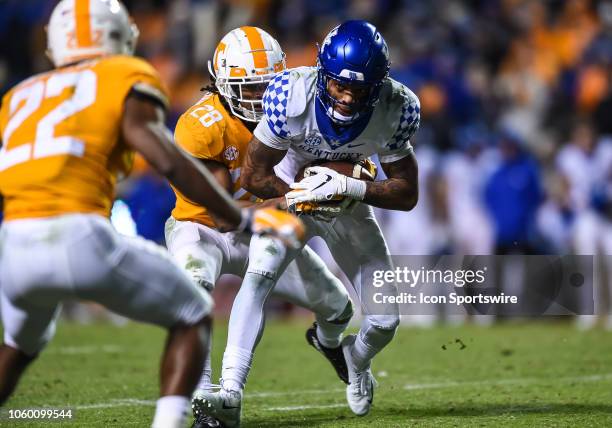 Kentucky Wildcats quarterback Terry Wilson is tackled by Tennessee Volunteers defensive back Baylen Buchanan during a college football game between...