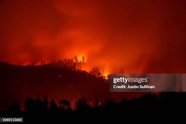 The Camp Fire burns in the hills on November 10, 2018 near Ororville, California. Fueled by high winds and low humidity the Camp Fire ripped through...