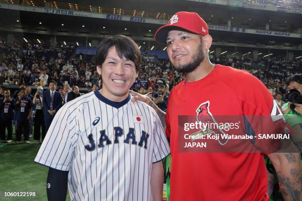 Catcher Takuya Kai of Japan and Catcher Yadier Molina of the St. Louis Cardinals pose for photographs prior to the game three of Japan and MLB All...