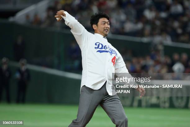 Former baseball player Takashi Saito throws a ceremonial first pitch prior to the game three of Japan and MLB All Stars at Tokyo Dome on November 11,...