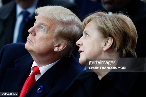 President Donald Trump and German Chancellor Angela Merkel attend a ceremony at the Arc de Triomphe in Paris on November 11, 2018 as part of...