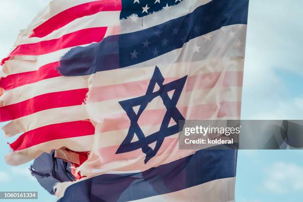 ragged national flags of israel and usa waving - bandera israelí fotografías e imágenes de stock