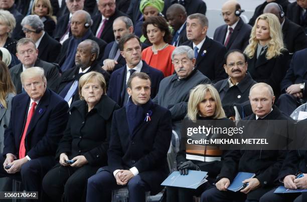 President Donald Trump, German Chancellor Angela Merkel, French President Emmanuel Macron and his wife Brigitte Macron and Russian President Vladimir...