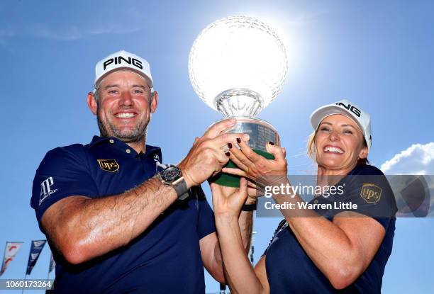 Lee Westwood of England and Caddie and partner Helen Storey lift the trophy after Lee Westwood wins during Day Four of the Nedbank Golf Challenge at...