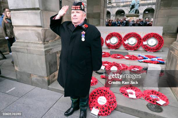 Veteran salutes beside the the newly-laid wreaths commemorating the Centenary of WW1 Armistice Day at the Stone of Remembrance, on November 11, 2018...