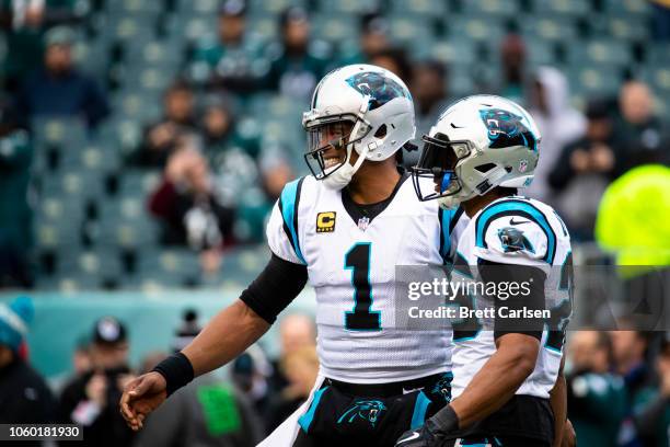 Cam Newton of the Carolina Panthers and Eric Reid stand together before the game against the Philadelphia Eagles at Lincoln Financial Field on...