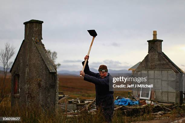 David Corbett digs a drain at his restoration project on his croft in Lewis on October 25, 2010 in Scotland, United Kingdom.