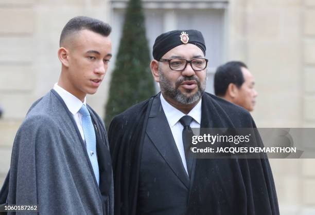 Moroccan King Mohammed VI and his son Crown Prince Hassan Moulay leave after a lunch at the Elysee Palace in Paris on November 11 during...