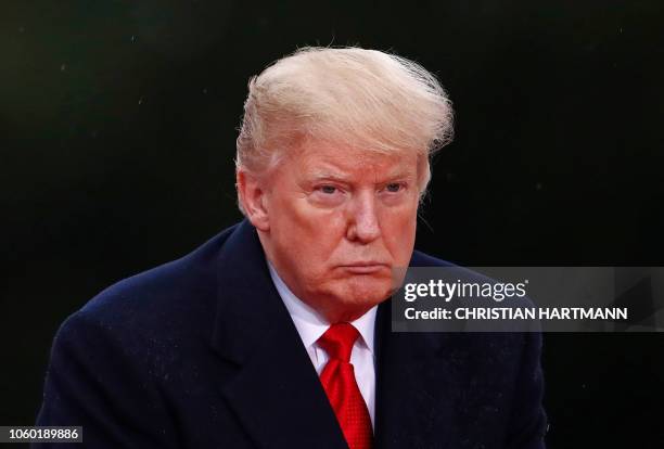 President Donald Trump looks on as he visits the American Cemetery of Suresnes, outside Paris, on November 11, 2018 as part of Veterans Day and the...