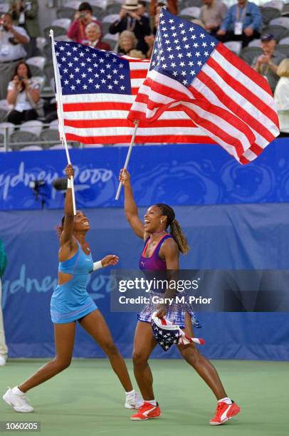 Venus and Serena Williams of the USA celebrate gold after winning the Womens Doubles Tennis Final at the NSW Tennis Centre on Day 13 of the Sydney...