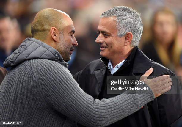 Josep Guardiola, Manager of Manchester City and Jose Mourinho, Manager of Manchester United embrace prior to the Premier League match between...