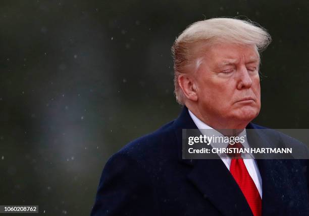 President Donald Trump closes his eyes as he visits the American Cemetery of Suresnes, outside Paris, on November 11, 2018 as part of Veterans Day...