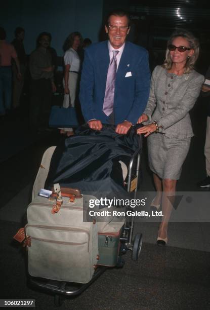 Roger Moore and Christina Tholstrup during Roger Moore and Christina Tholstrup Sighted at Los Angeles International Airport at Los Angeles...