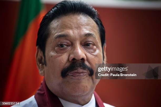 Acting Prime Minister Mahinda Rajapaksa speaks to members of his party and the media as he formally joins the Sri Lanka Freedom party as the...