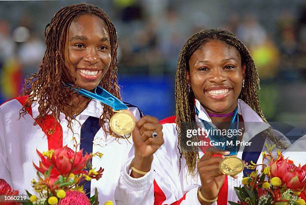 Venus and Serena Williams of the USA celebrate gold after winning the Womens Doubles Tennis Final at the NSW Tennis Centre on Day 13 of the Sydney...