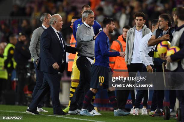 Quique Setien manager of Real Betis pats Lionel Messi of Barcelona on the back after the La Liga match between FC Barcelona and Real Betis Balompie...