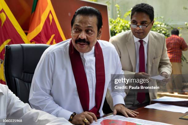 Acting Prime Minister Mahinda Rajapaksa speaks to members of his party and the media as he formally joins the Sri Lanka Freedom party as the...