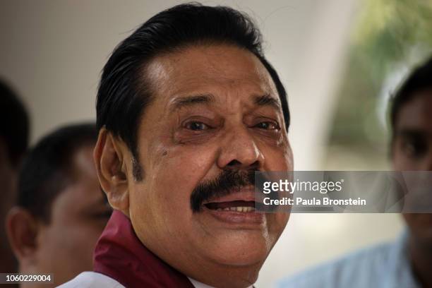 Acting Prime Minister Mahinda Rajapaksa reacts to members of his party and the media as he formally joins the Sri Lanka Freedom party as the...